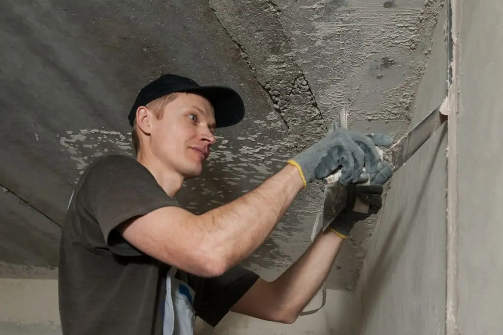 Stucco contractor fixing stucco wall