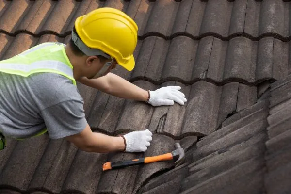 roof contractor repairing old tile