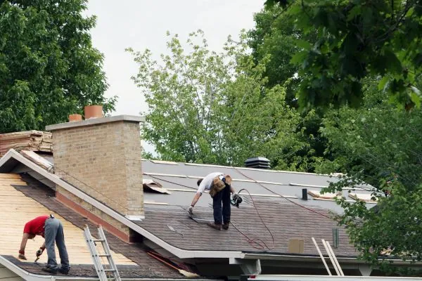 team of roof contractor repairing old residential roof 