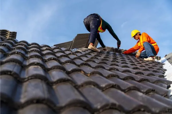 two roof contractor repairing residential roof