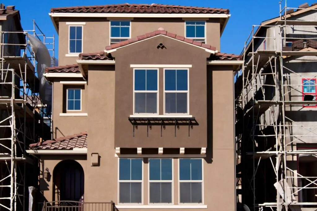 stucco home new construction exterior and blue sky