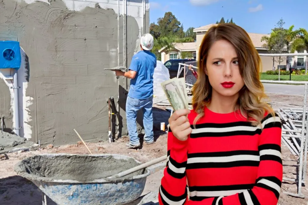 woman holding dollar thinking of how much stucco construction works